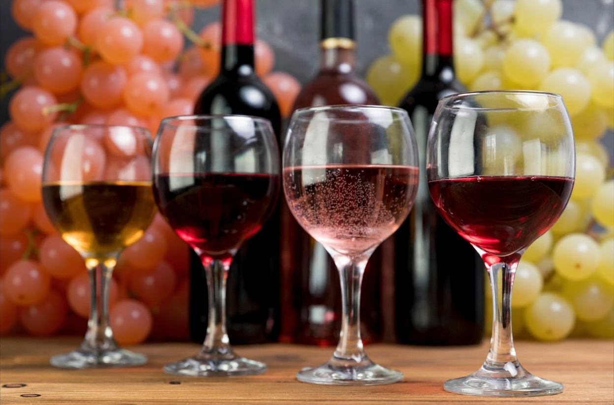 Elegant wine glasses filled with red wine on a sophisticated table setting with soft candlelight